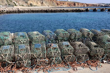 Lobster traps on the harbour wall in Rosso Do Veigaの写真素材