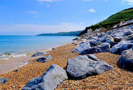 A scenic landscape view of the pebbles and rocks on the beach at Beesandsの写真素材