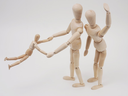 Wooden figures of child playing with parents の写真素材