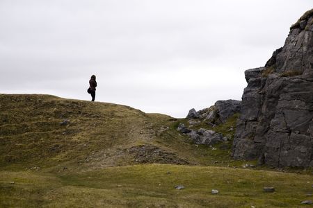 a person on the edge of chiff or hillの写真素材