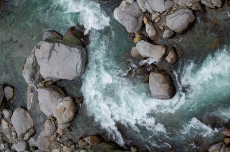 the power of the water hits on the rocks in the river