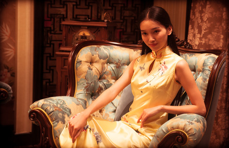 Cheongsam beauty sitting on the couchのeditorial素材