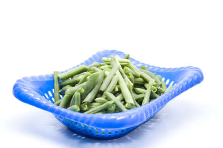 String beans in blue basket