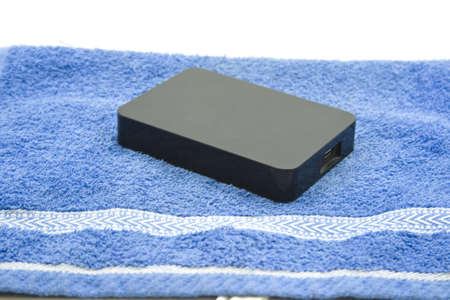 External Black Harddrive on Blue Towel の写真素材