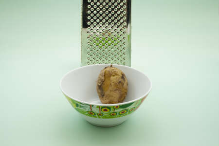 Potato  in Bowl with Grater の写真素材