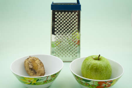 Potato and Apple in Bowl with Grater の写真素材
