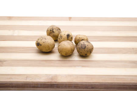 Brown Potatos on Wooden Plateの写真素材