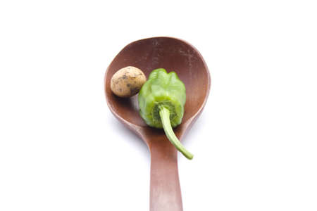 Brown Potatos with Capsicum  in Wooden Spoonの写真素材
