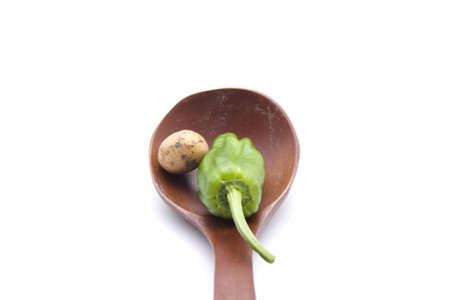 Brown Potatos with Capsicum  in Wooden Spoonの写真素材