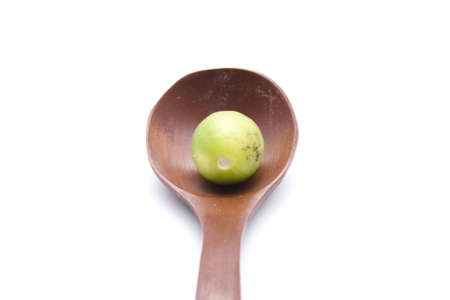 Yellow Lemon in Wooden Spoonの写真素材