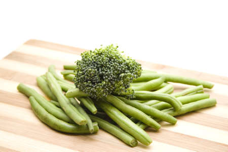 Fresh Broccoli with String beans on wooden plateの写真素材