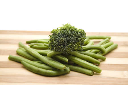 Fresh Broccoli with String beans on wooden plateの写真素材