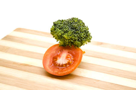 Tomato with Broccoli on wooden plateの写真素材