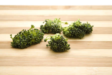 Fresh Green Broccoli on wooden plateの写真素材