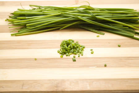 Fresh Chives on wooden plateの写真素材