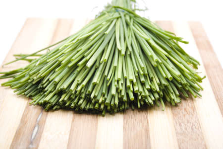 Fresh Green Chives on Wooden Plate の写真素材