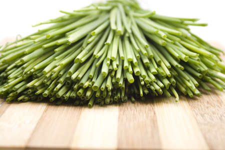 Fresh Green Chives on Wooden Plate の写真素材