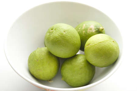 Fresh Green Lemon in Bowl の写真素材