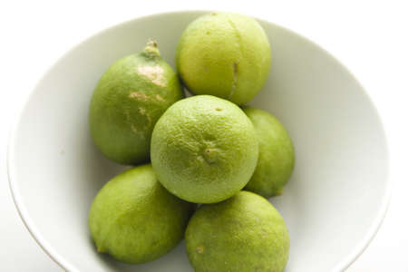 Fresh Green Lemon in Bowl の写真素材