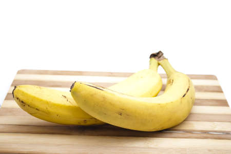 Yellow Banana on wooden Plate の写真素材