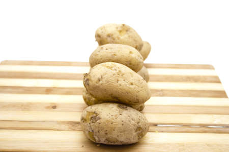 Cooked Potatos on wooden Plate の写真素材