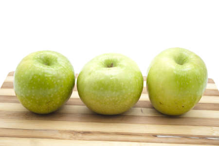 Green Apples on wooden plate の写真素材