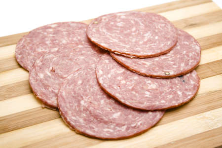 Salami  Cuts on wooden plateの写真素材