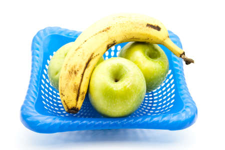 Green Apples with Yellow Banana in Basket の写真素材