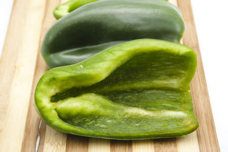 Green Bell Pepper on Wooden Plate の写真素材