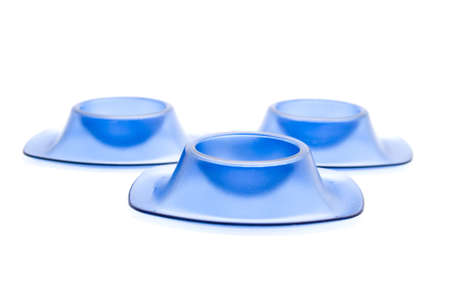 Blue egg cup for Eggs on white background の写真素材