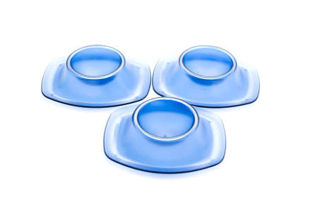 Blue egg cup for Eggs on white background の写真素材