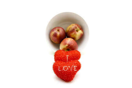 Red Hearts with Nectarine on white background の写真素材