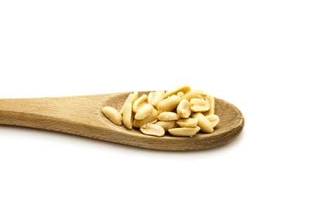 Salted Peanuts on wooden cooking spoon の写真素材