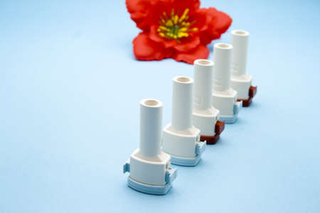 Asthma Inhaler on blue background の写真素材