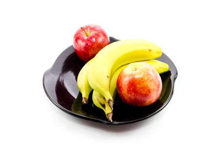 Fresh yellow Bananas with Red apples on Ceramic Plate の写真素材