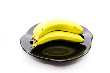 Fresh yellow Bananas on Ceramic Plate の写真素材