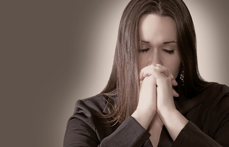 Woman Praying with her hands togetherの写真素材