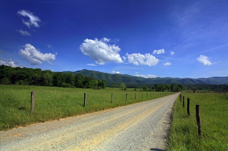 Summer day with country road in the mountainsの写真素材