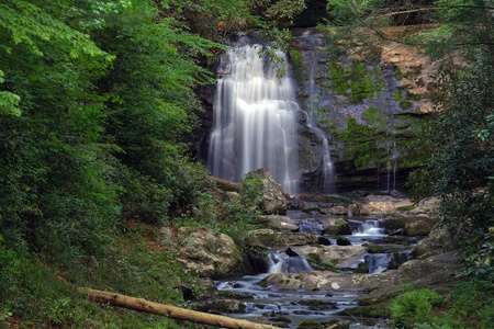 Waterfall in the mountains in the middle of the forestの写真素材