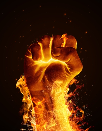 Hand consumed in flames on black backgroundの写真素材