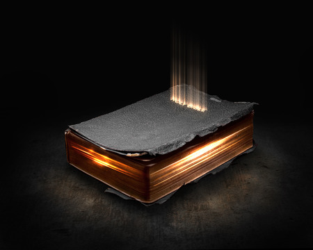 Glowing Bible with light coming from the pages.