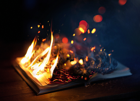 Close up of a book on fire with huge flames.の写真素材
