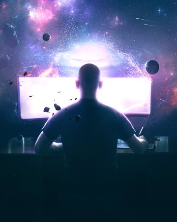 A man designs artwork on a computer with a beautiful space sceneの写真素材