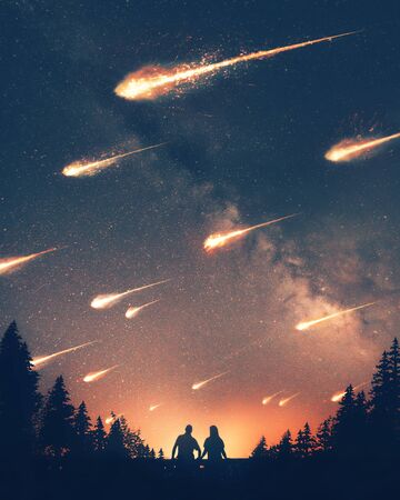 A man and woman look on as asteroids crash to the earthの写真素材