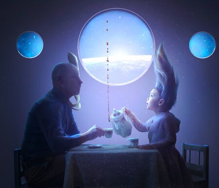 A father and daughter share a tea party in spaceの写真素材