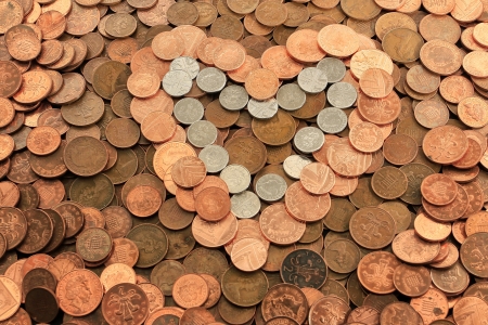 Heart shaped from a pile of UK coinsの写真素材