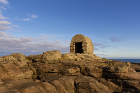 Old Dynamite hut on the rocks at Seahouses,Northumberlandの写真素材
