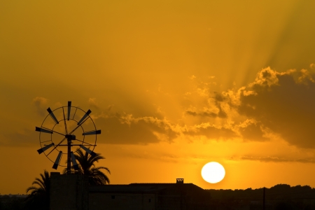 Sunset on the island of Mallorca, the sun setting behind one of the may windmills on the island の写真素材