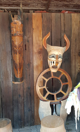 Phi Ta Khon. Wooden carving of a ghost mask at the entrance to a templeの写真素材