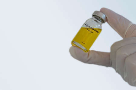 Image of Hand holds Coronavirus Covid-19 Vaccine glass bottle.の写真素材